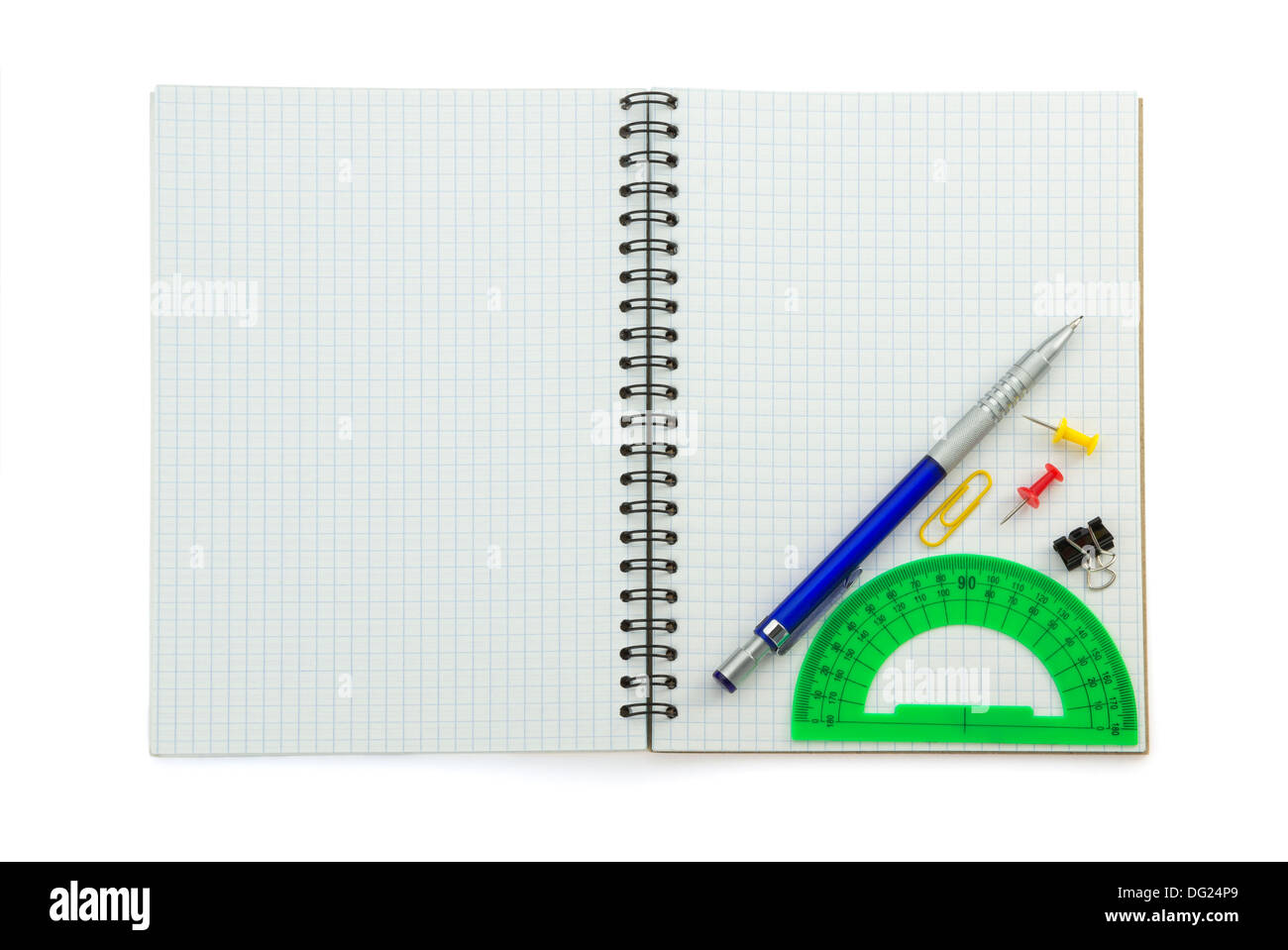 school supplies on checked notebook isolated at white background Stock Photo