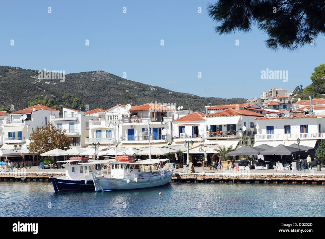 Boats moored in the old harbor in Skiathos Town on the Greek Island of Skiathos, a popular tourist destination in the Aegean. Stock Photo