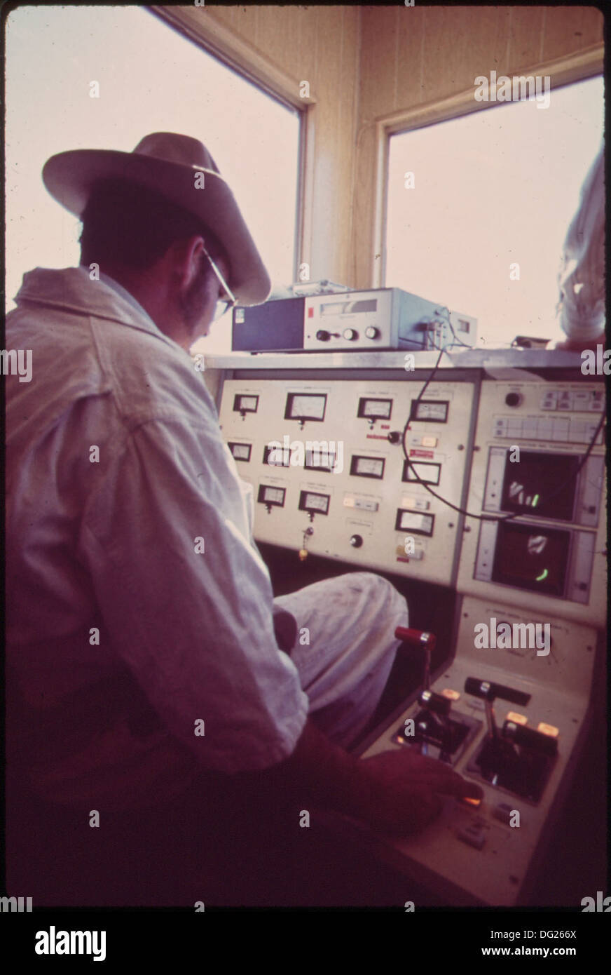 A technician works at the data control center for the Linear Induction Motor Test Vehicle (LIMTV), involved in testing advanced transportation technologies. This image captures the technical environment of the LIMTV program. Stock Photo