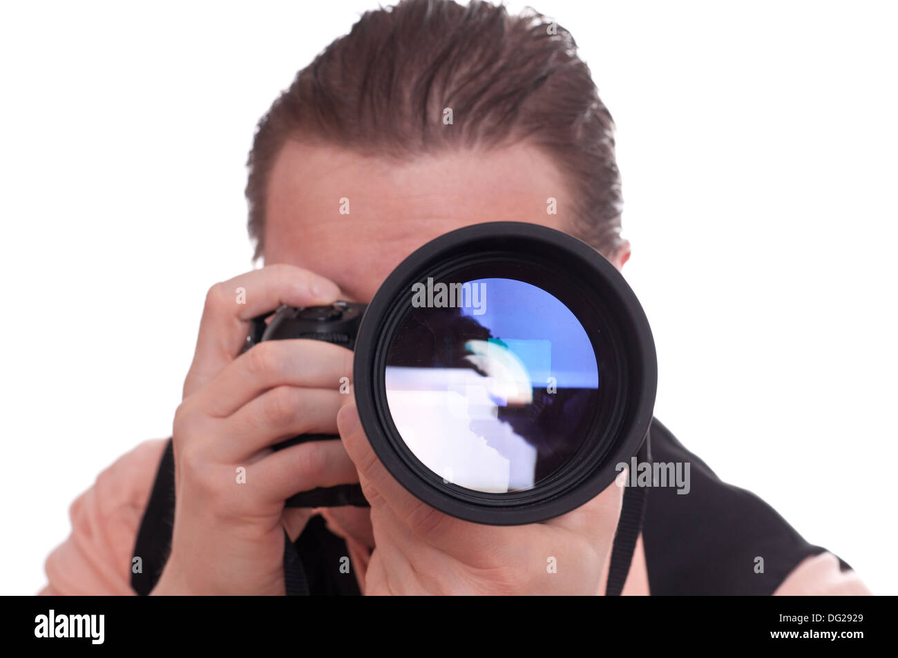 Male photographer with a singlelens reflex camera and huge telephoto