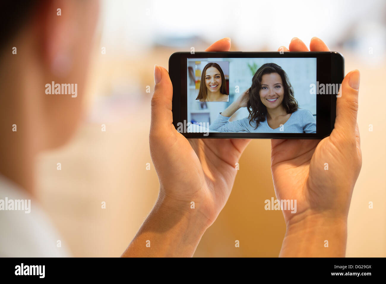 Woman chatting with her friend on smartphone Stock Photo