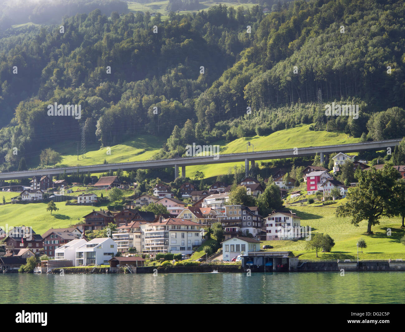 Boat trip on Lake Lucerne Switzerland, approaching Beckenried, Erlibach, the motorway and mountainside behind Stock Photo