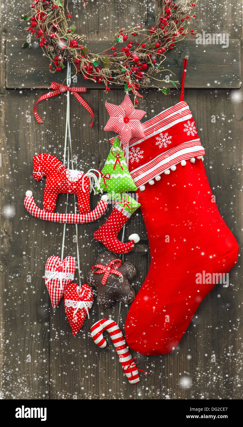 christmas decoration santa's sock and handmade toys over rustic wooden background Stock Photo