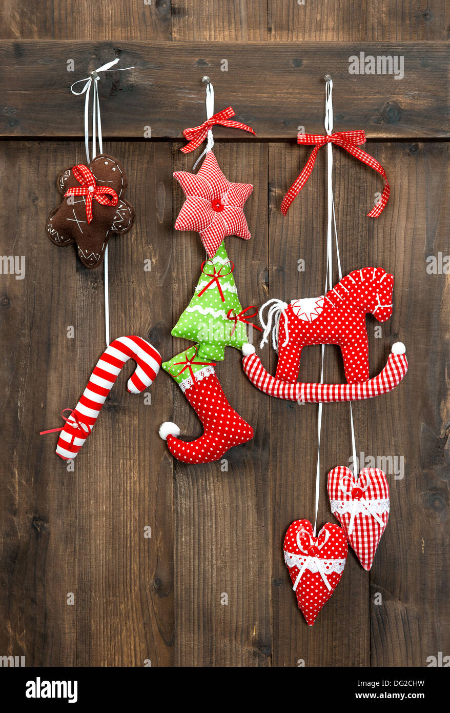 christmas decoration handmade toys hanging over rustic wooden background. nostalgic retro style picture Stock Photo
