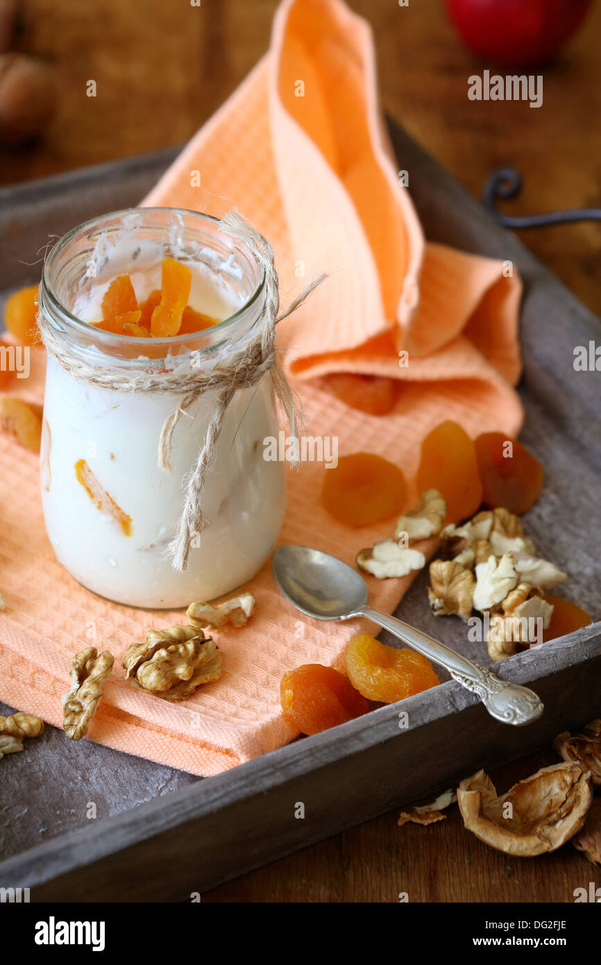 fresh yogurt with pieces of apricot, food close up Stock Photo