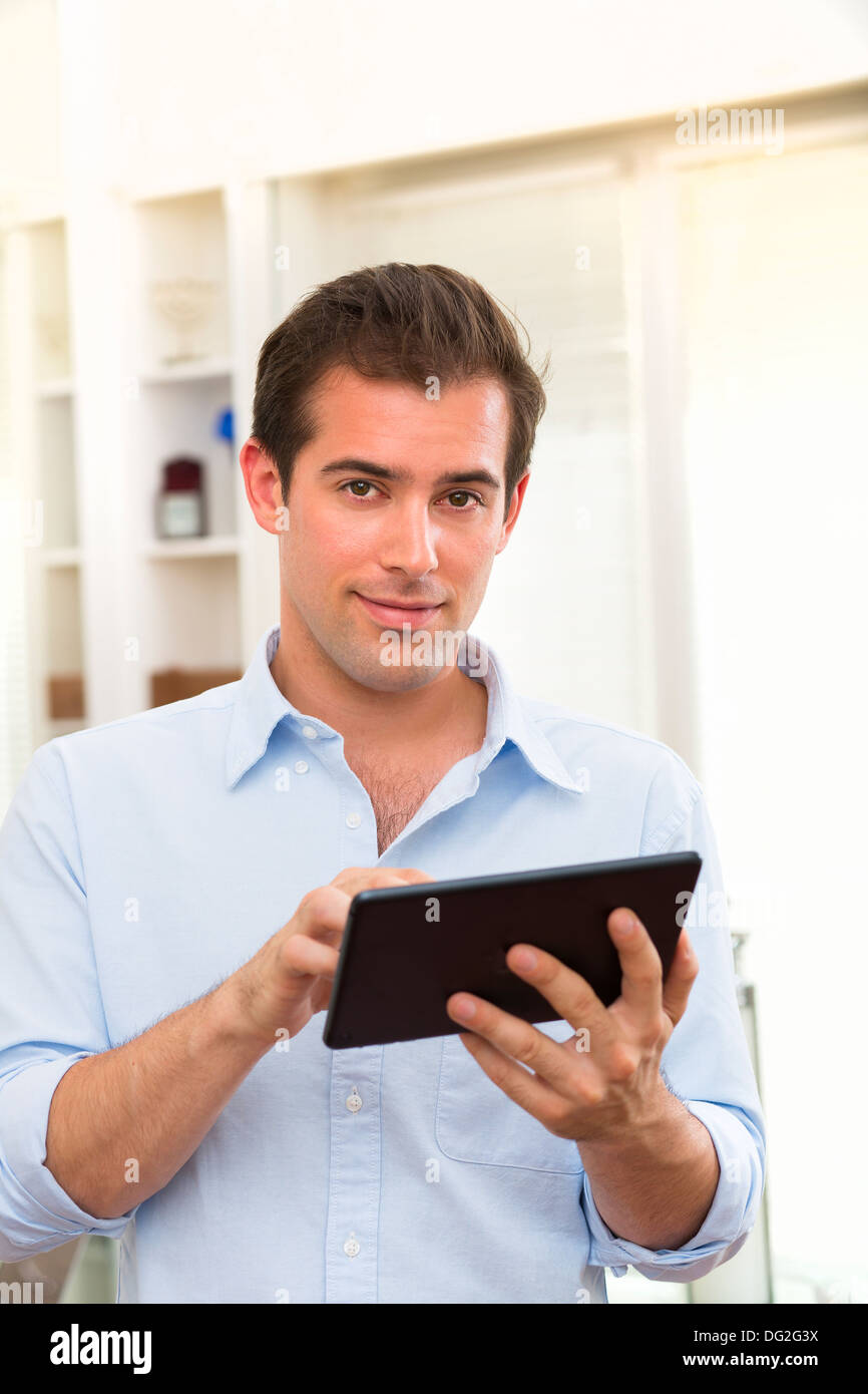 Male working on digital tablet at home Stock Photo
