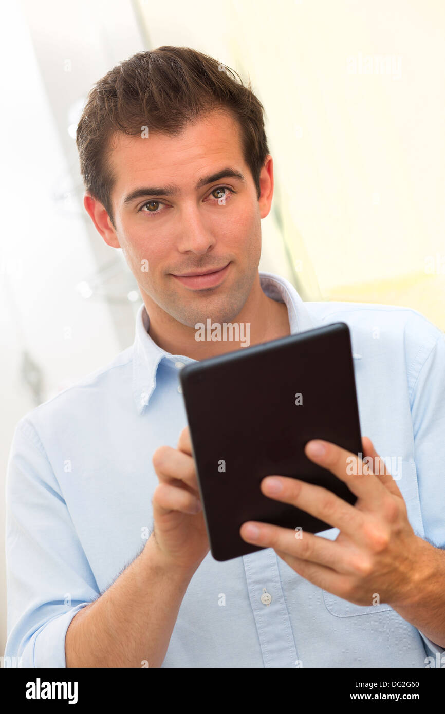 Male working on digital tablet at home Stock Photo