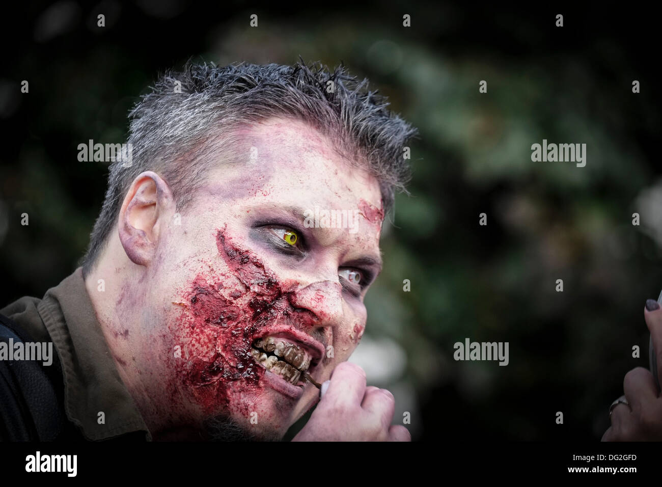 October 12th 2013 A participant in the annual Zombie Invasion of London finishing his makeup.  Photographer: Gordon Scammell/Alamy Live News Stock Photo