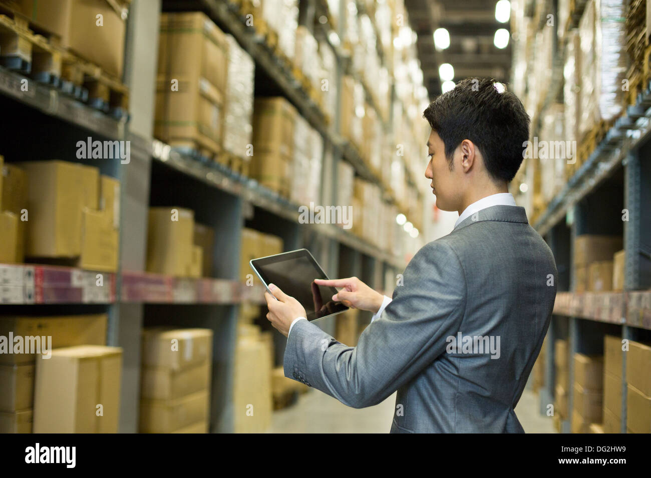 Businessman using digital tablet in warehouse Stock Photo