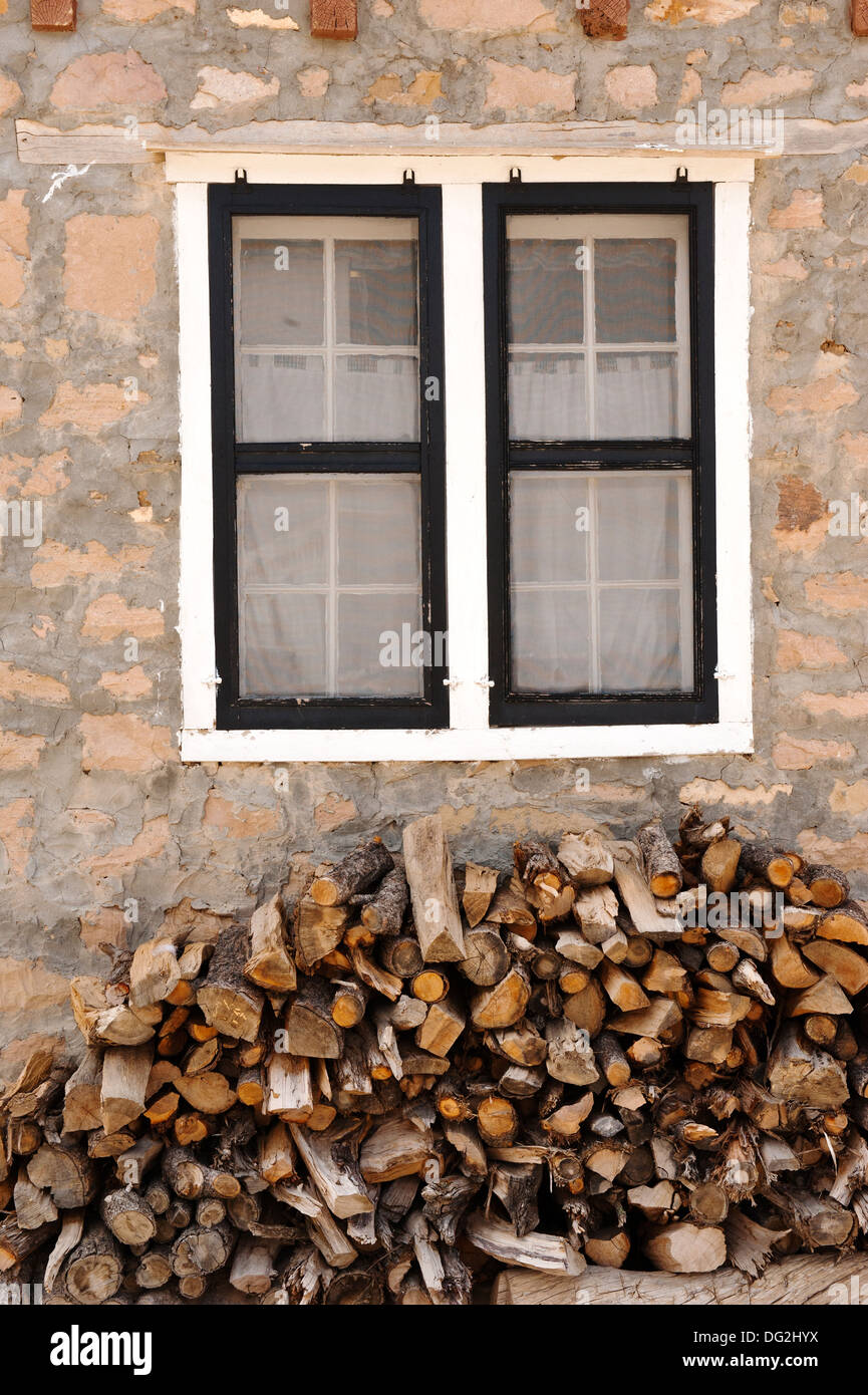 Window and Wood Pile in front of a building at a Pueblo in New Mexico Stock Photo