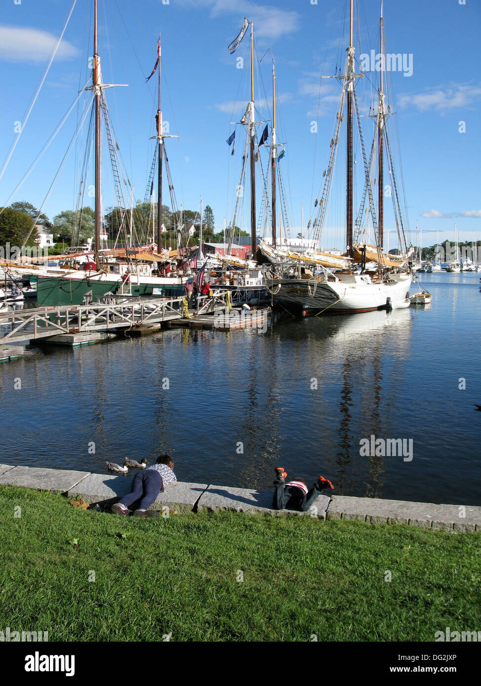 Two children at waters edge Camden Harbor Maine Coast New England USA Stock Photo