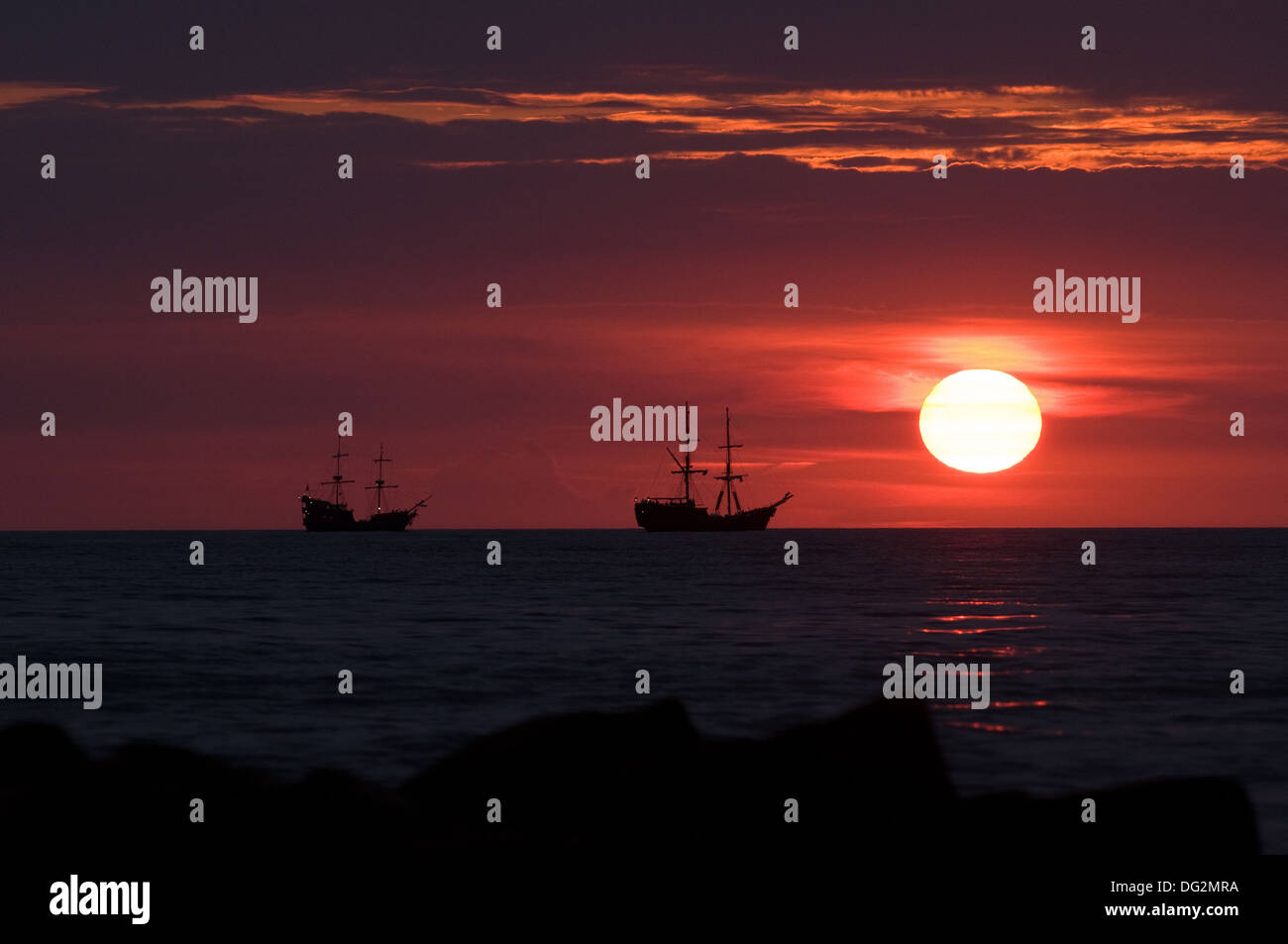 sunset-at-the-sea-with-ships-stock-photo-alamy