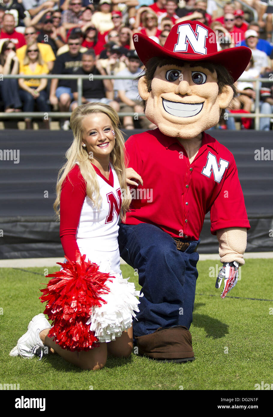 West Lafayette, Indiana, USA. 12th Oct, 2013. October 12, 2013: Nebraska cheerleader and mascot enjoying the game during NCAA Football action between the Nebraska Cornhuskers and the Purdue Boilermakers at Ross-Ade Stadium in West Lafayette, Indiana. Nebraska defeated Purdue 44-7. Credit:  csm/Alamy Live News Stock Photo