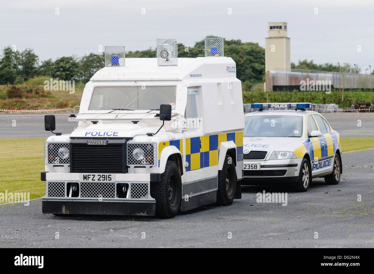 PSNI Landrover and squad car parked outside the disused HMP Maze Prison Stock Photo