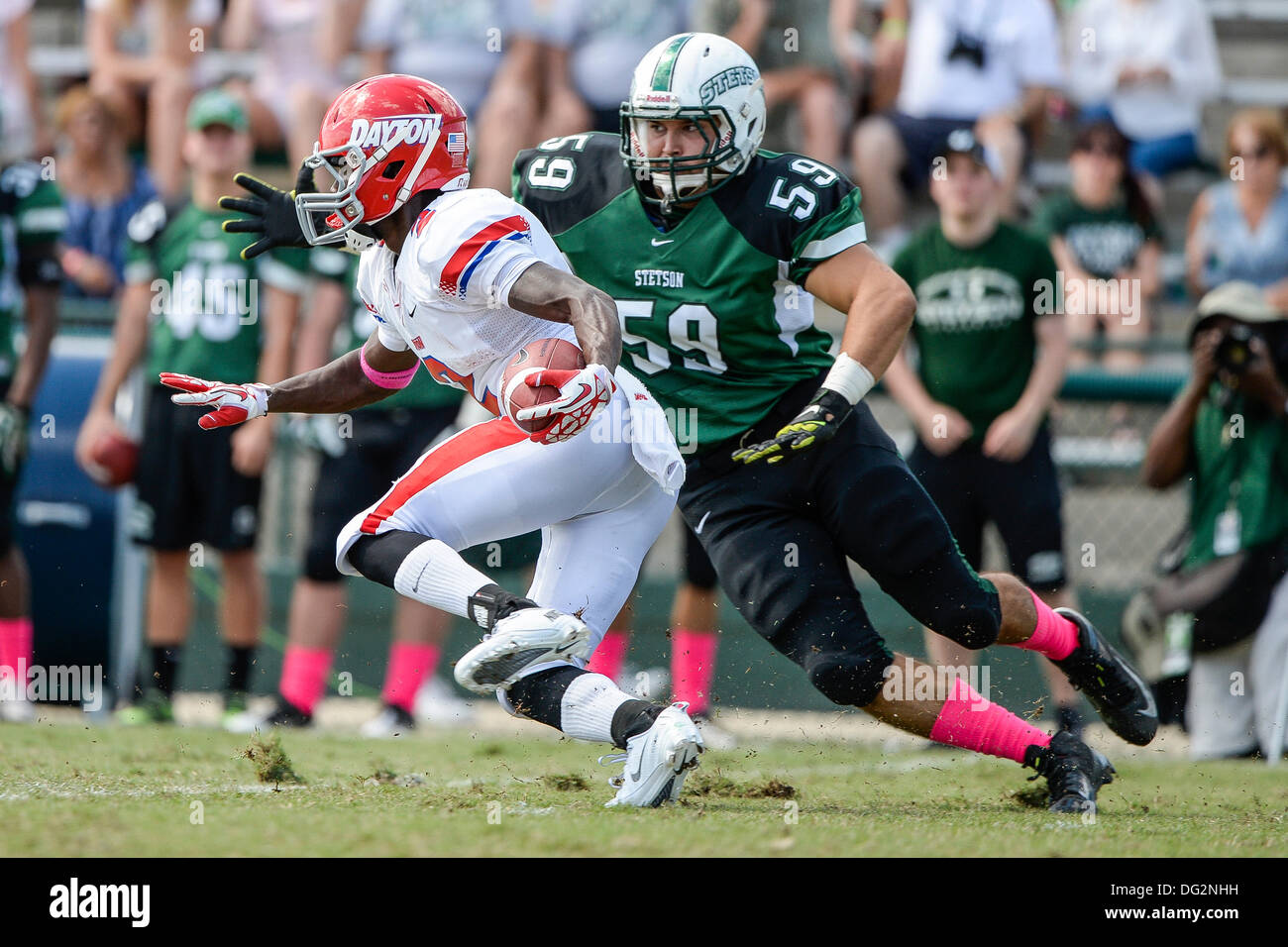 DeLand, Florida, USA. 12th Oct, 2013. Dayton Flyers wide receiver Gary Hunter (2) attempts to avoid Stetson Hatters linebacker Cole Ripple (59) during first half NCAA Football game action between the Dayton Flyers and Stetson Hatters at Spec Martin Stadium in DeLand, Florida. Credit:  csm/Alamy Live News Stock Photo