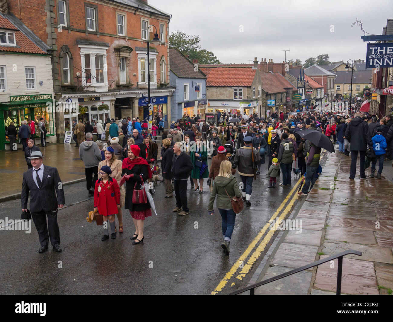 A dense crowd of people in Pickering Market Place North Yorkshire England UK, many in period dress for Wartime and 1940's week-end 2013 Stock Photo