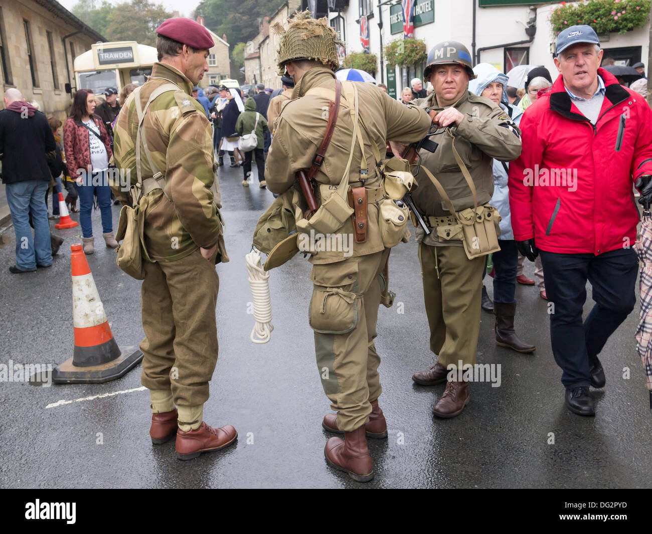 Three men dressed as WW2 soldiers, a British paratrooper an American infantry man and an American Military Policeman in Pickering North Yorkshire England UK for the Wartime and 1940's week-end 2013 Stock Photo