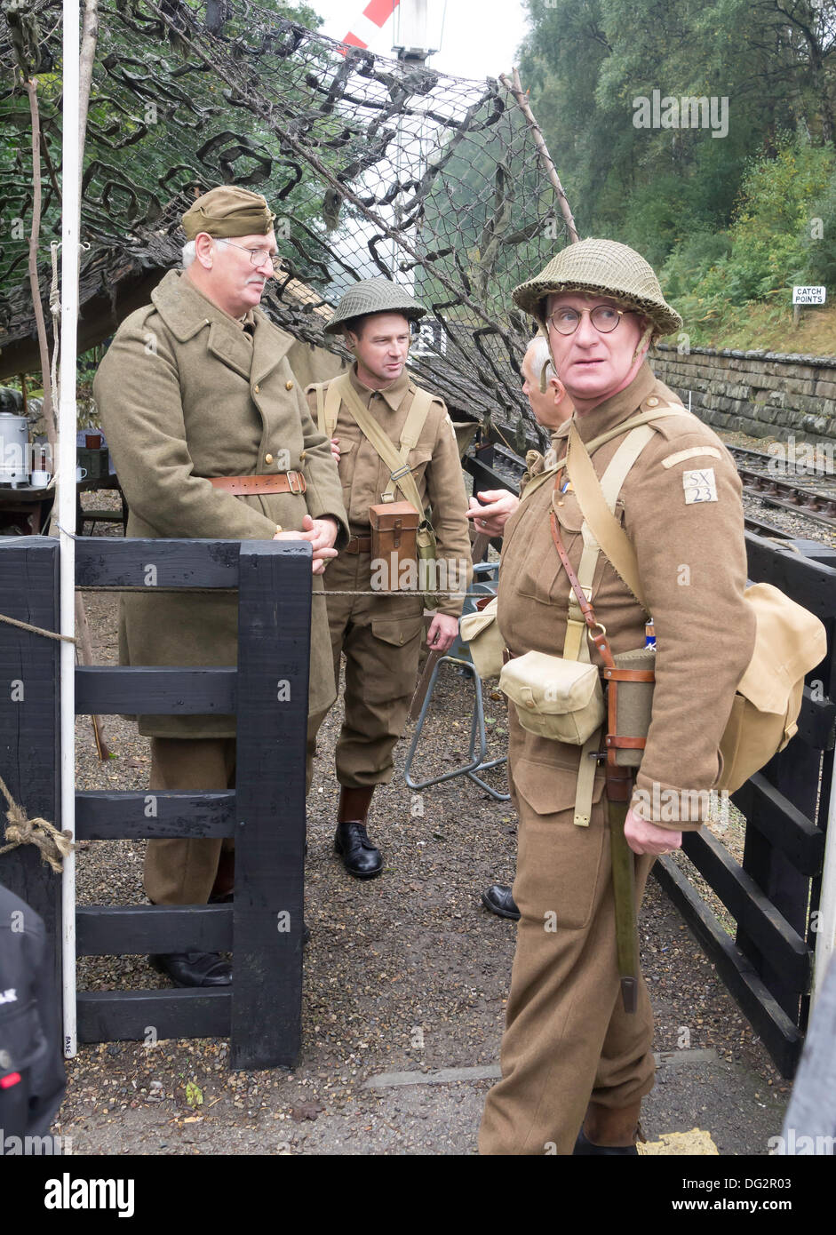 Three men dressed as WW2 Home Guard soldiers, guarding Goathland Station on The North Yorkshire Moors Railway during the Railway in Wartime week-end October 2013 Stock Photo