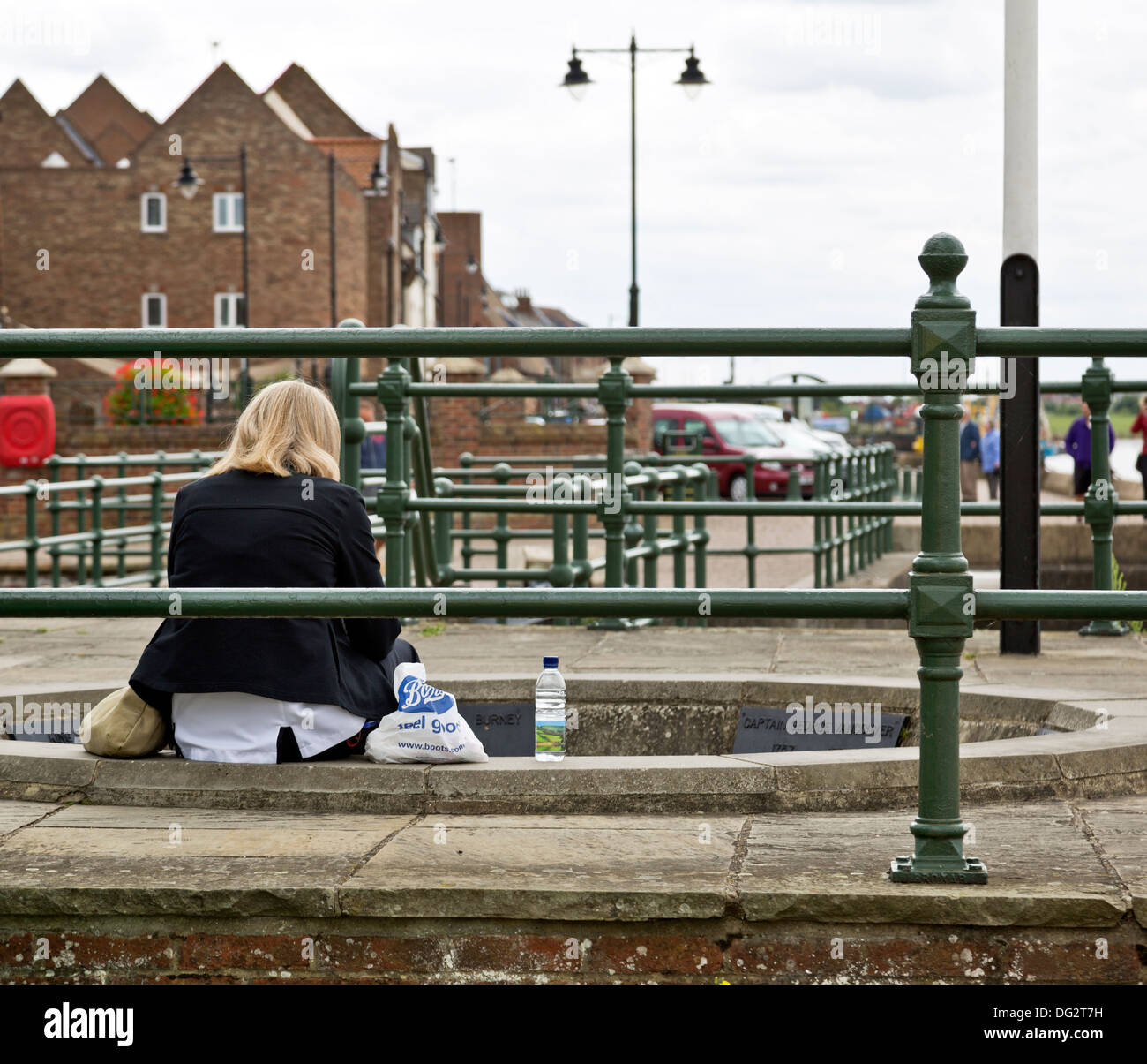 Woman sitting alone hi-res stock photography and images - Alamy
