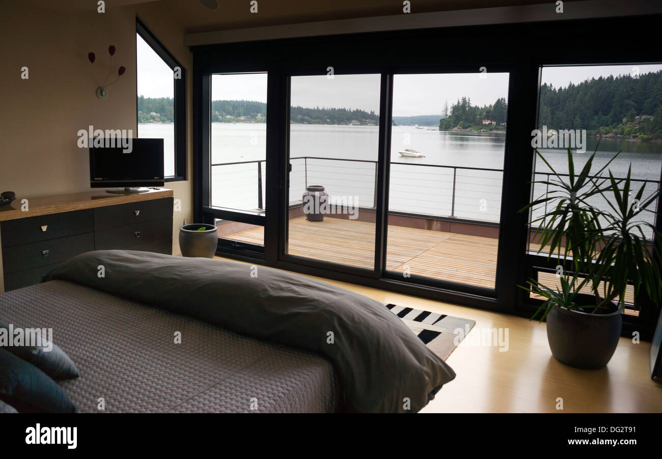 An affluent home owner has a water view from master bedroom Stock Photo