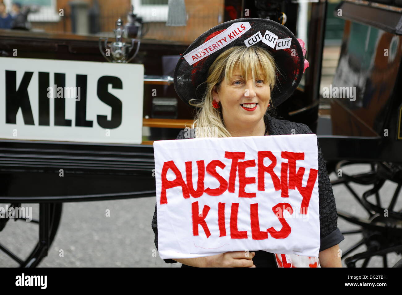 Dublin, Ireland. 12th October 2013. A member of the Spectacle of Defiance & Hope holds a sign that reads 'Austerity Kills'. Unions called for a protest march through Dublin, ahead of the announcing of the 2014 budget next week. They protested against cuts in Social Welfare, Health and Education and for an utilisation of alternative revenue sources by the government. © Michael Debets/Alamy Live News Stock Photo