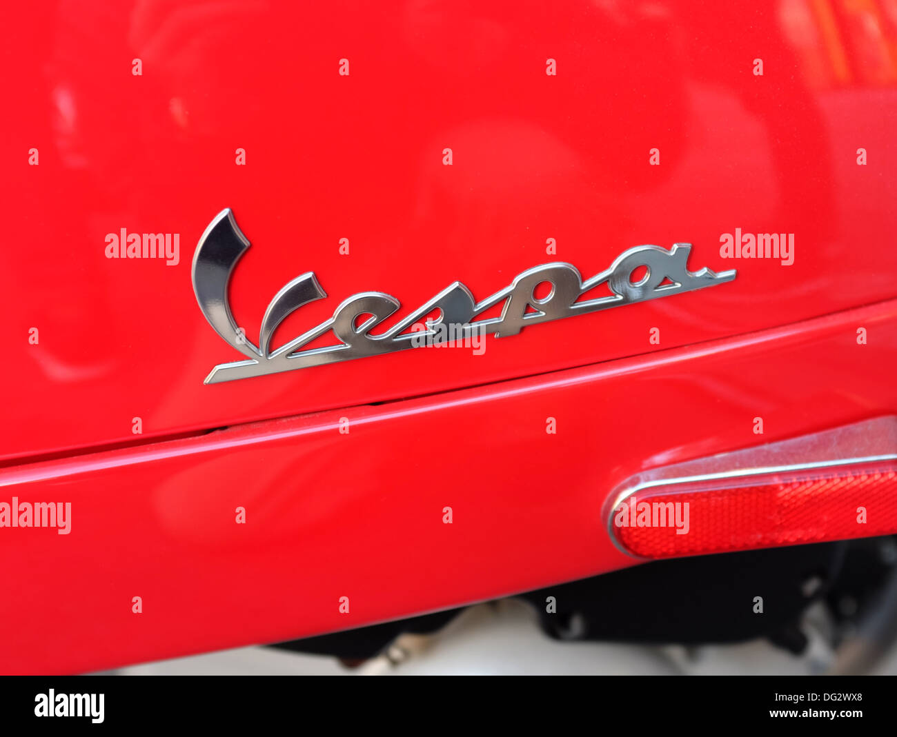 Detail of Vespa logo on red Vespa scooter. Stock Photo