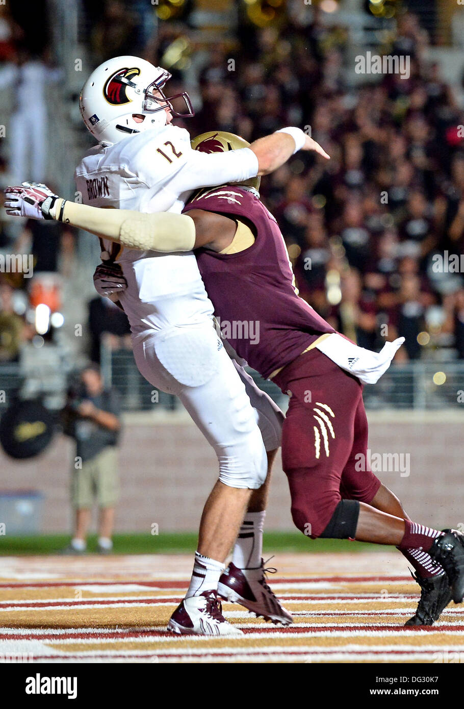 San Marcos, TX, USA. 12th Oct, 2013. ULM quarterback quarterback Brayle Brown #12 is hit by Texas State safety Justin Iwuji #8 as he throws a pass during NCAA football game at Jim Wacker Field in San Marcos, TX. ULM defeat Texas State 21-14. © csm/Alamy Live News Stock Photo