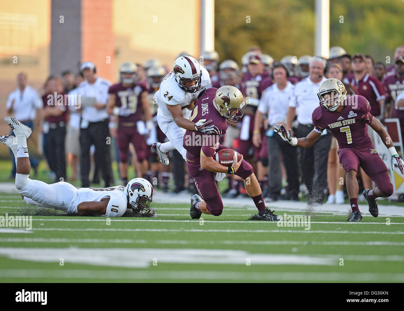 San Marcos, TX, USA. 12th Oct, 2013. Texas State quarterback Tyler Jones #2 is tackled by ULM cornerback Trey Caldwell #24 during NCAA football game at Jim Wacker Field in San Marcos, TX. ULM defeat Texas State 21-14. © csm/Alamy Live News Stock Photo