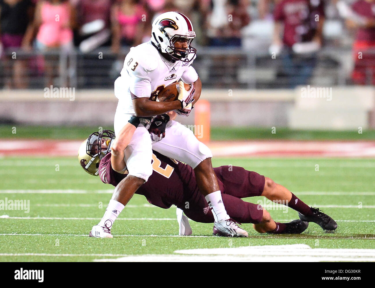San Marcos, TX, USA. 12th Oct, 2013. Texas State defensive back Donta Clanton #21 tackles wide receiver Ajalen Holley #83 during NCAA football game at Jim Wacker Field in San Marcos, TX. ULM defeat Texas State 21-14. © csm/Alamy Live News Stock Photo