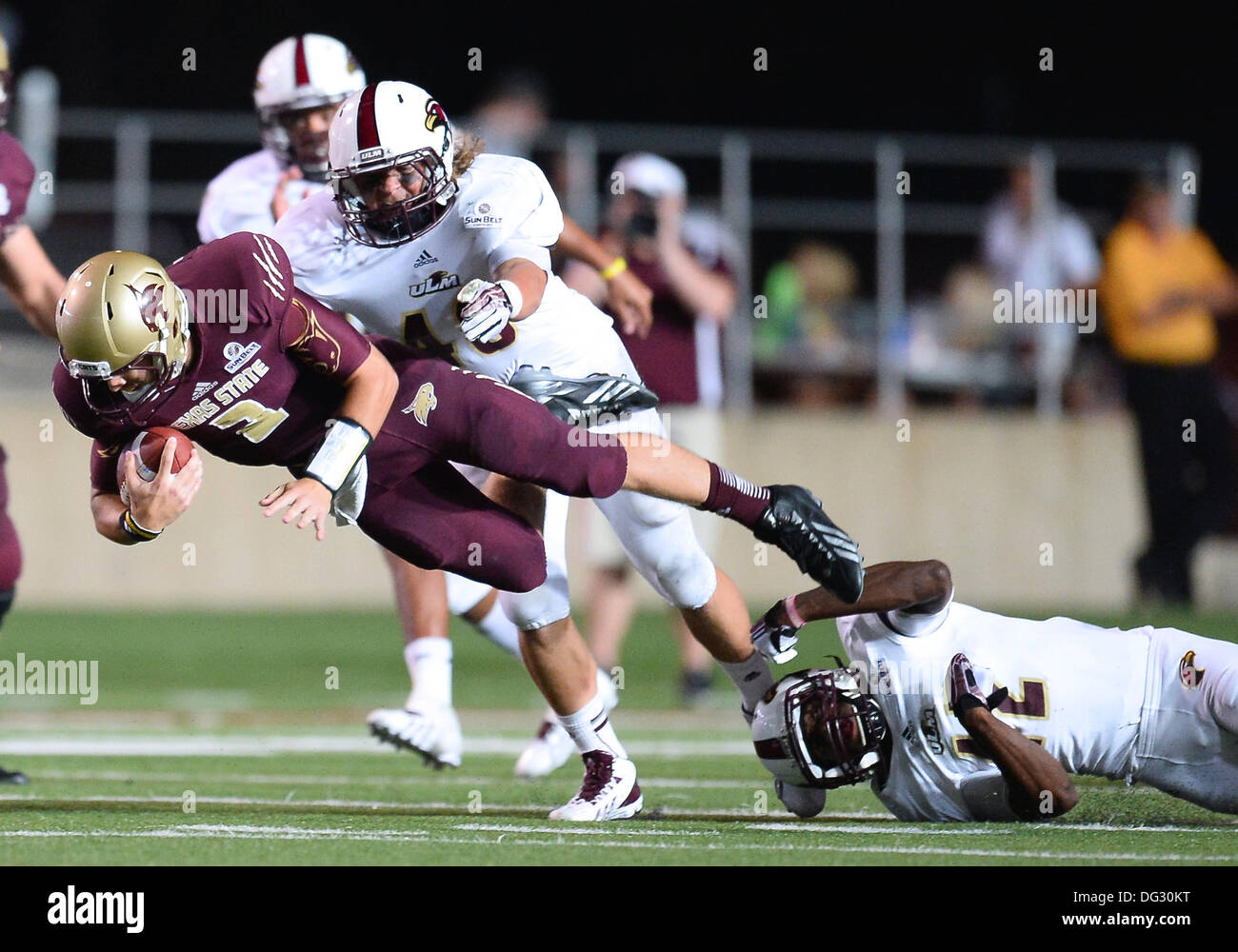 San Marcos, TX, USA. 12th Oct, 2013. Texas State wide receiver Andy Erickson #13 is tackled by ULM linebacker Hunter Kissinger #48 during NCAA football game at Jim Wacker Field in San Marcos, TX. ULM defeat Texas State 21-14. © csm/Alamy Live News Stock Photo