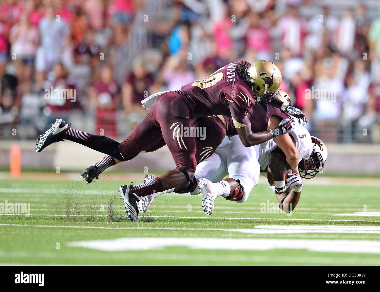 San Marcos, TX, USA. 12th Oct, 2013. Texas State safety safety Aaron Matthews #10 tackles ULM running back Centarius Donald #5 during NCAA football game at Jim Wacker Field in San Marcos, TX. ULM defeat Texas State 21-14. © csm/Alamy Live News Stock Photo