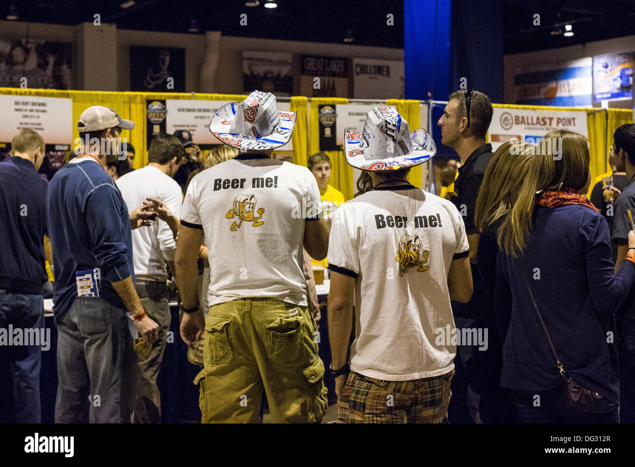 Denver, CO  Oct. 12, 2013. Two participants of the 2013 Great American Beer Festival wear t-shirts that say Beer Me and cardboard hats made from Coors Light Boxes as they travel between booths at the festival in order to  sample one of the 4,809 beer entries from 745 breweries from all over the US and Washington DC. © Ed Endicott/Alamy Live News Stock Photo