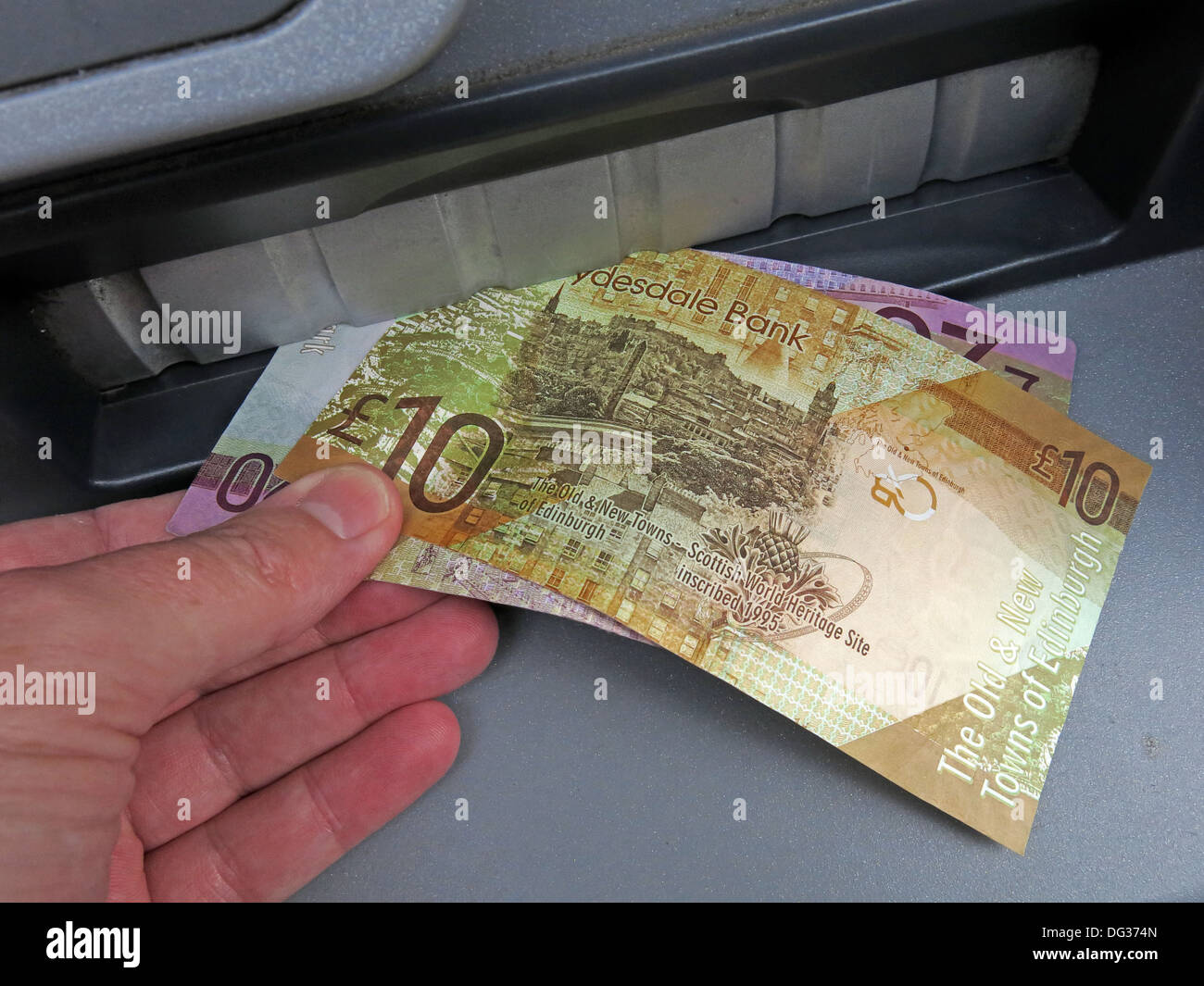 Scots Pound Sterling Notes being pulled from a Clydesdale bank ATM cash dispensing machine , Scotland UK Stock Photo
