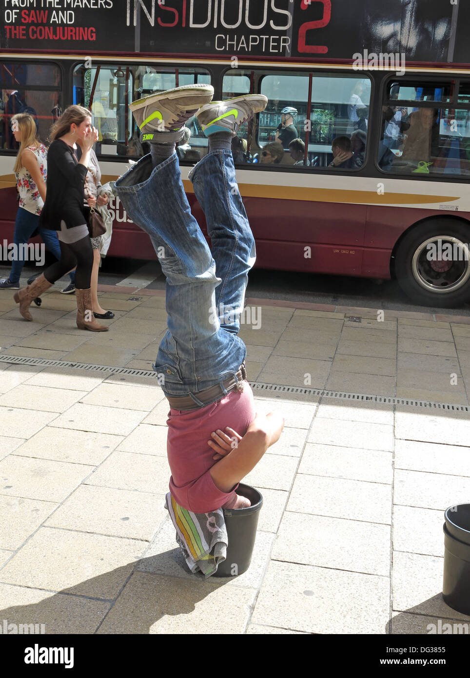 Fringe Busker in Princes St, Edinburgh Festival week - upside down in a bucket, Scotland, UK, EH2 2AN Stock Photo