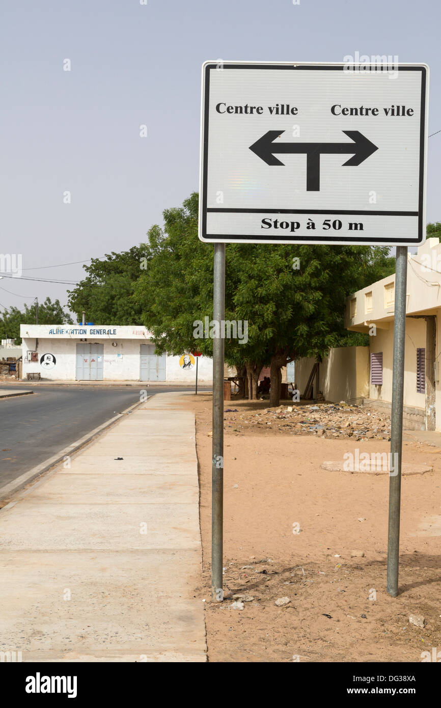 Senegal, Touba. Street Sign Pointing Opposite Ways to the City Center. Stock Photo
