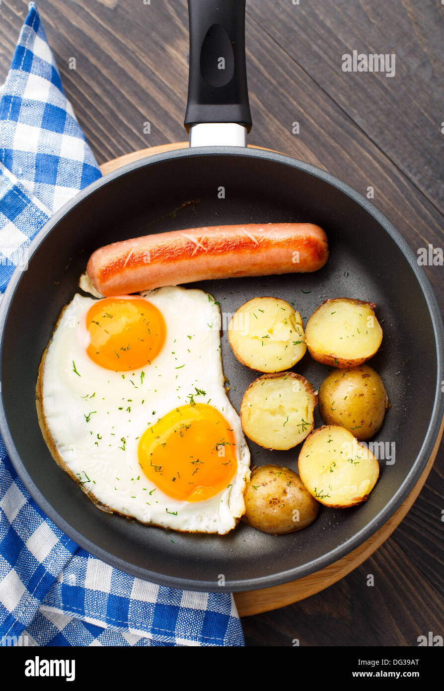 Breakfast with eggs, sausage and potato Stock Photo