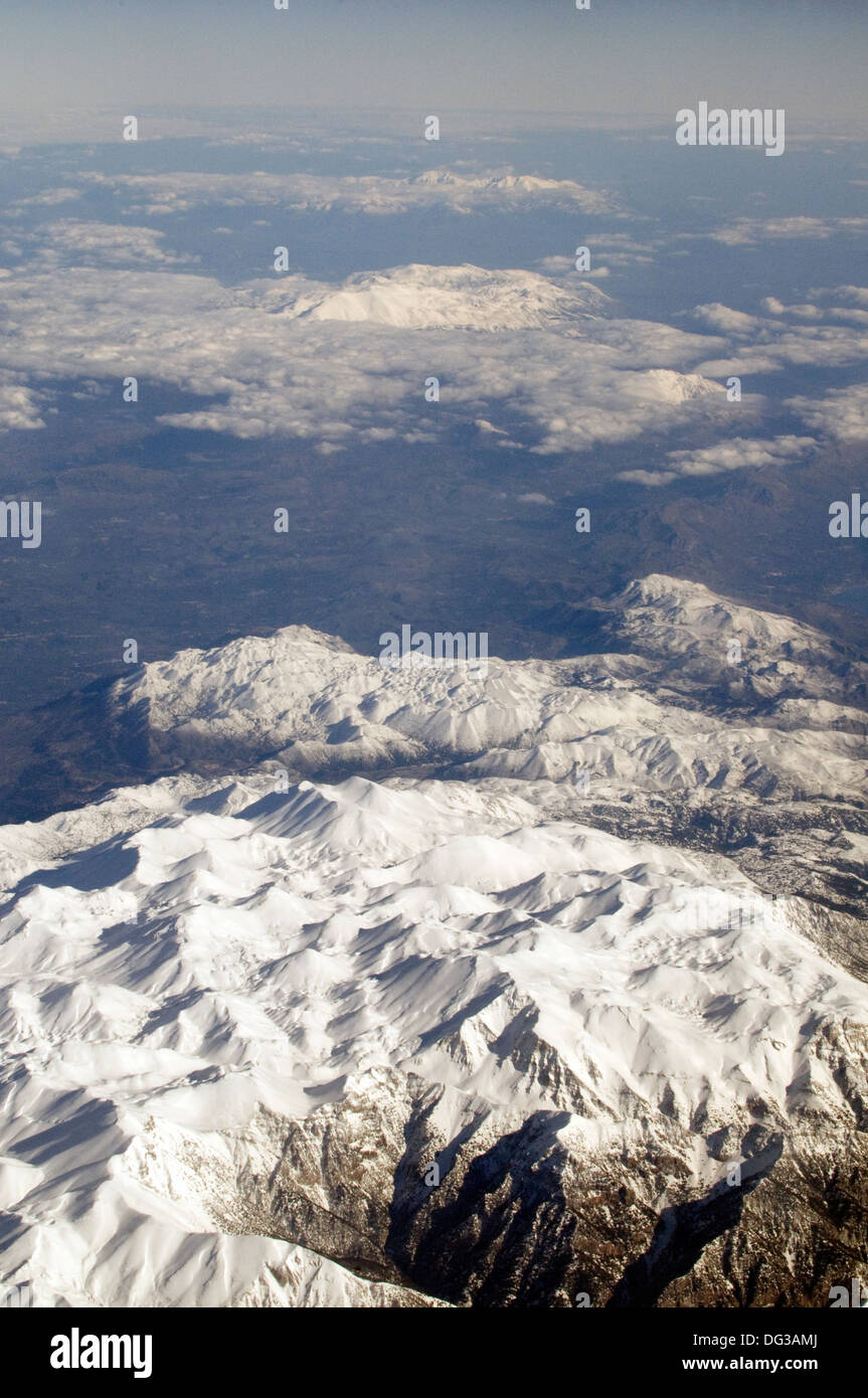 Aerial view of glistening white snow-clad mountain range of the Alps Stock Photo
