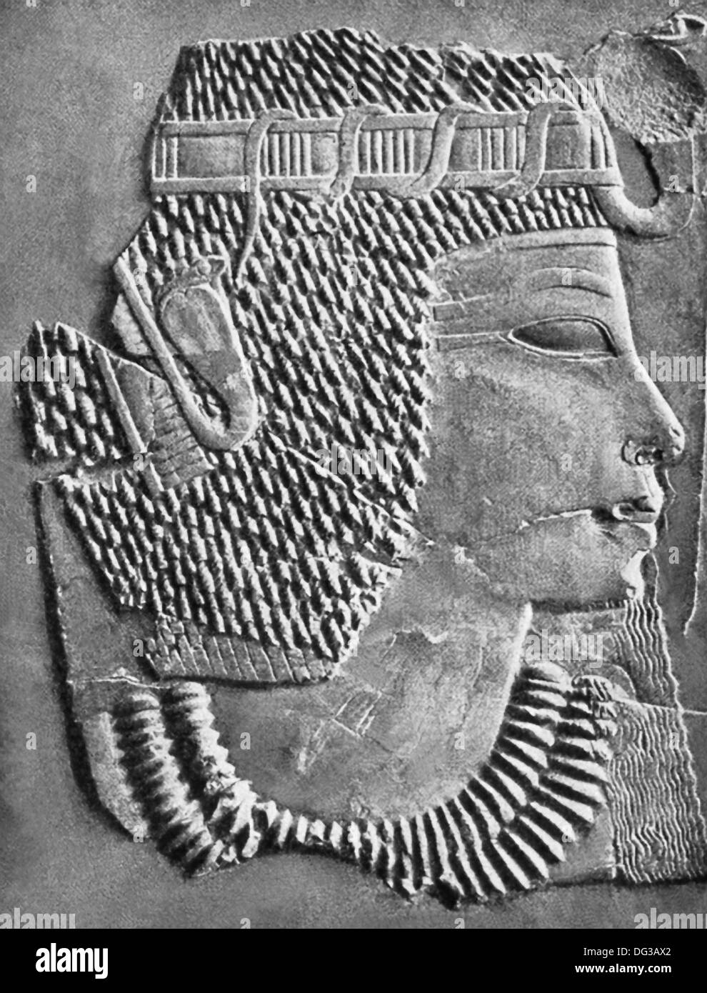 This carved relief shows the head of 18th Dynasty pharaoh Amenhotep III with the royal crown and rearing cobra. Stock Photo