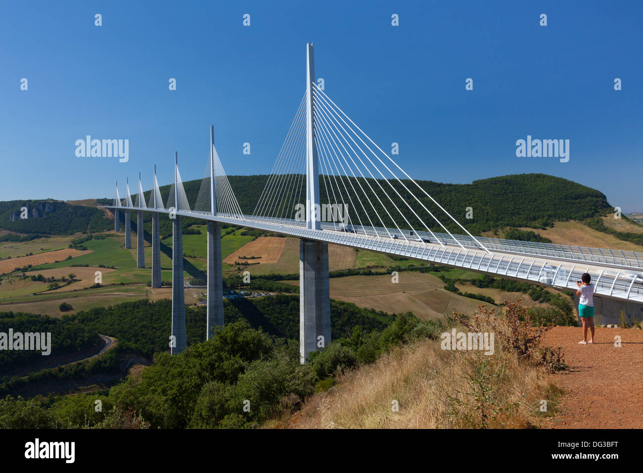 Woman Photographing Millau Viaduct, Viaduc de Millau, Architect Norman Foster and Engineer Michel Virlogeux Stock Photo