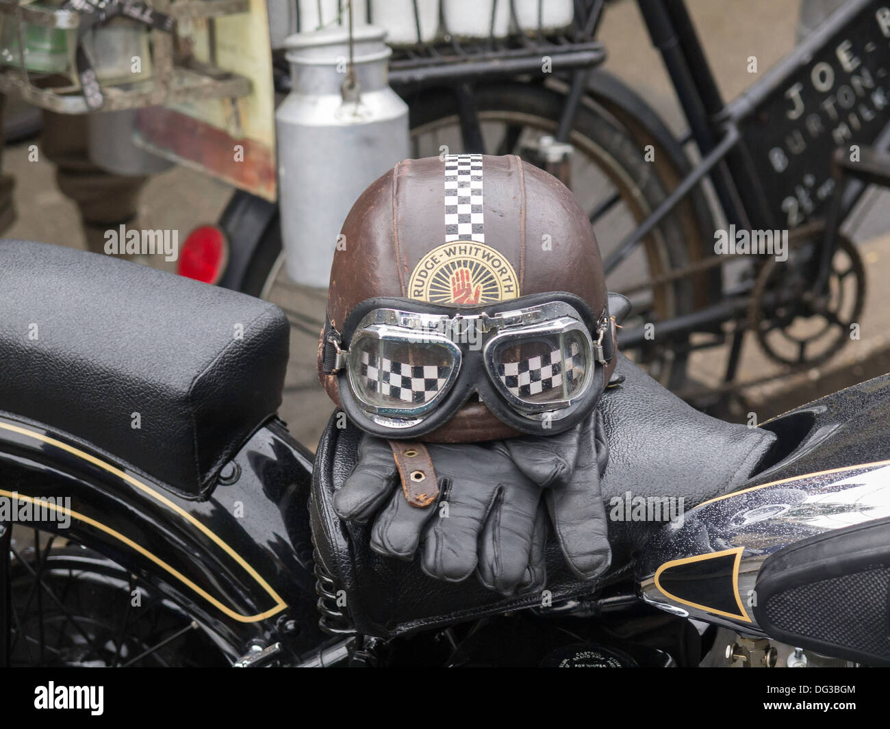 A riders helmet gloves and goggles on a motorcycle on display in Pickering North Yorkshire for Wartime and 1940's week-end 2013 Stock Photo