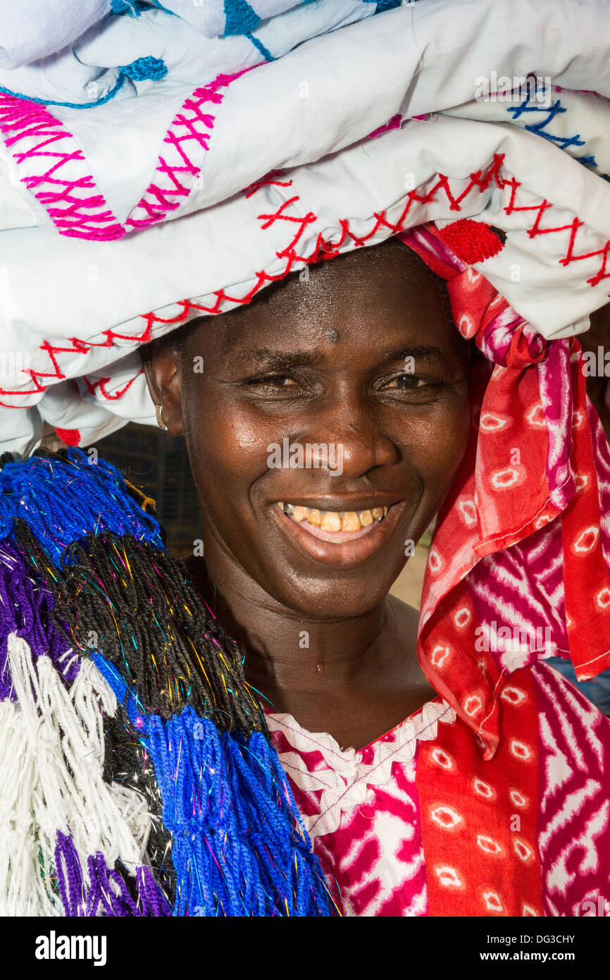 Senegal, Touba. Woman Selling Cloth in the Market. Stock Photo