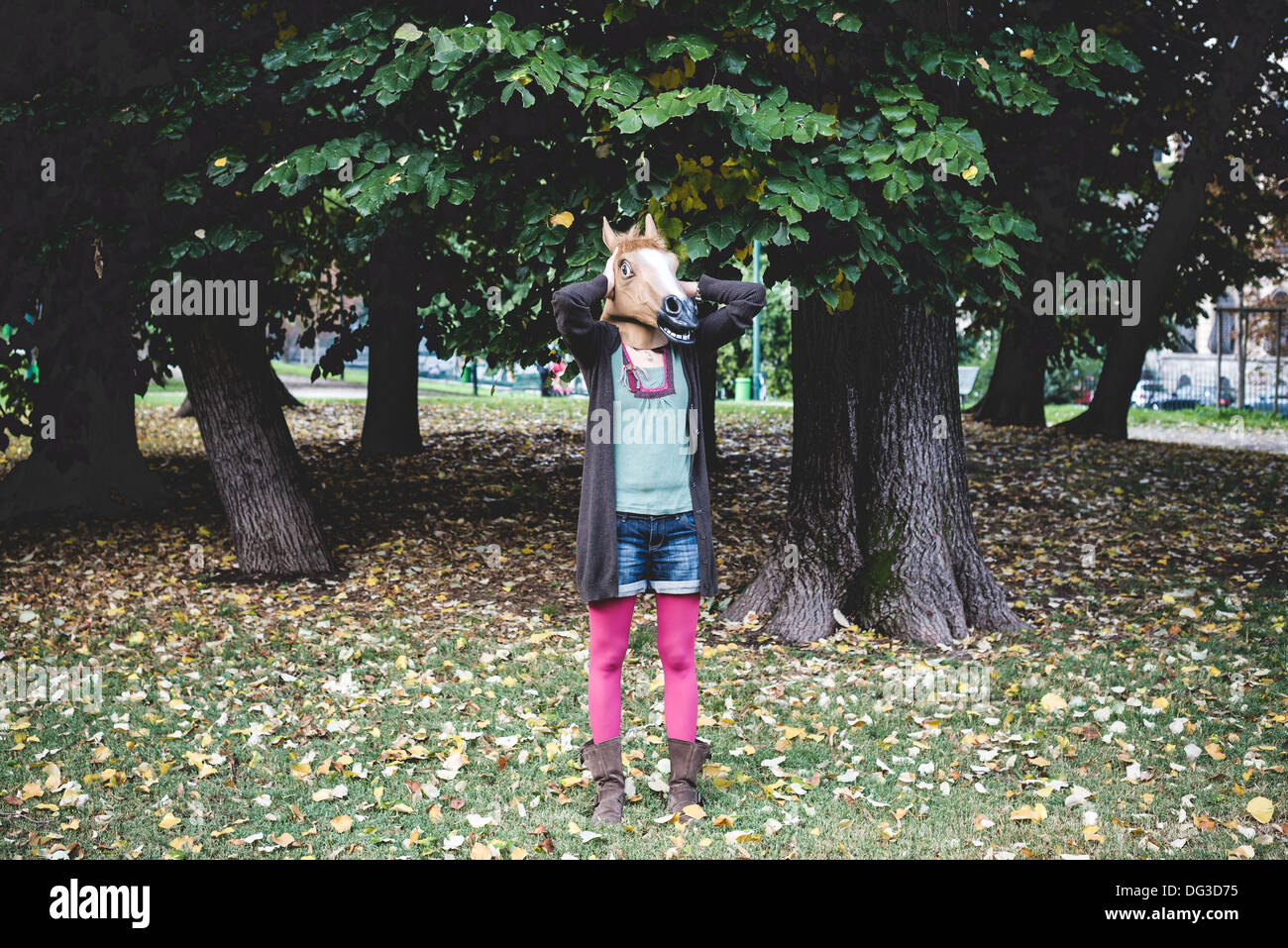 horse mask woman in the park autumn Stock Photo Alamy