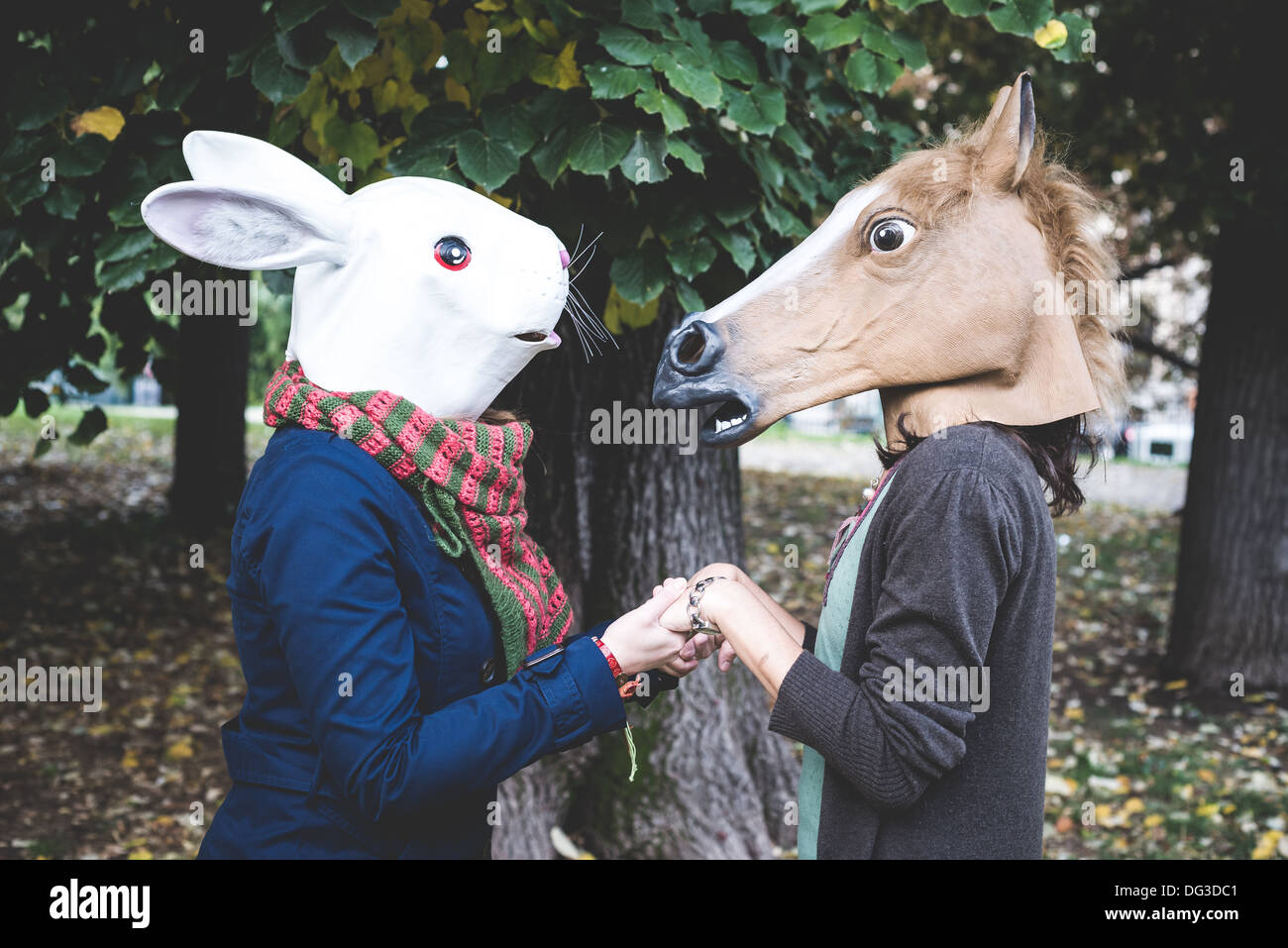 horse and rabbit mask women in the park autumn Stock Photo Alamy