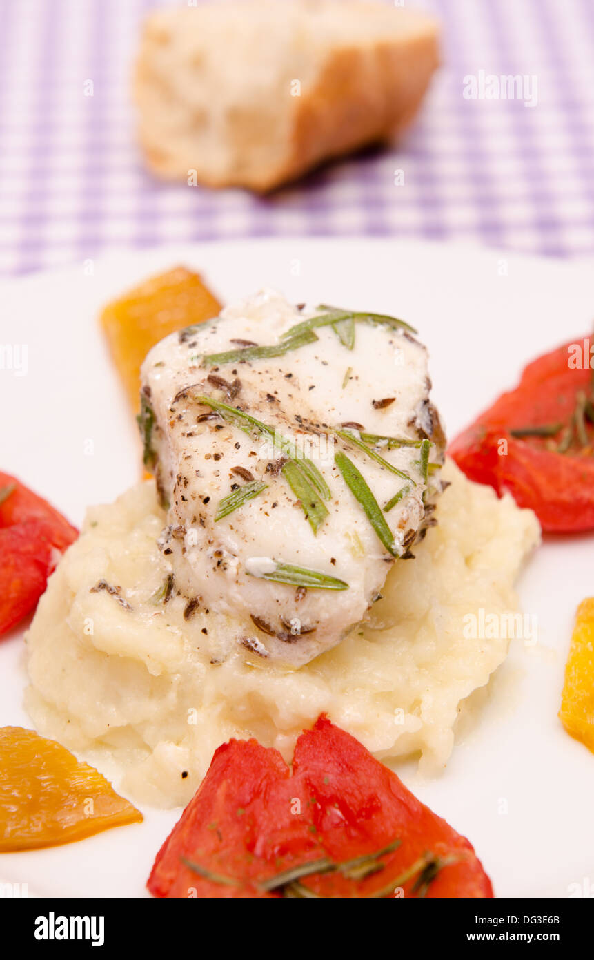 Roasted monkfish with tomatoes and pepper on a plate Stock Photo