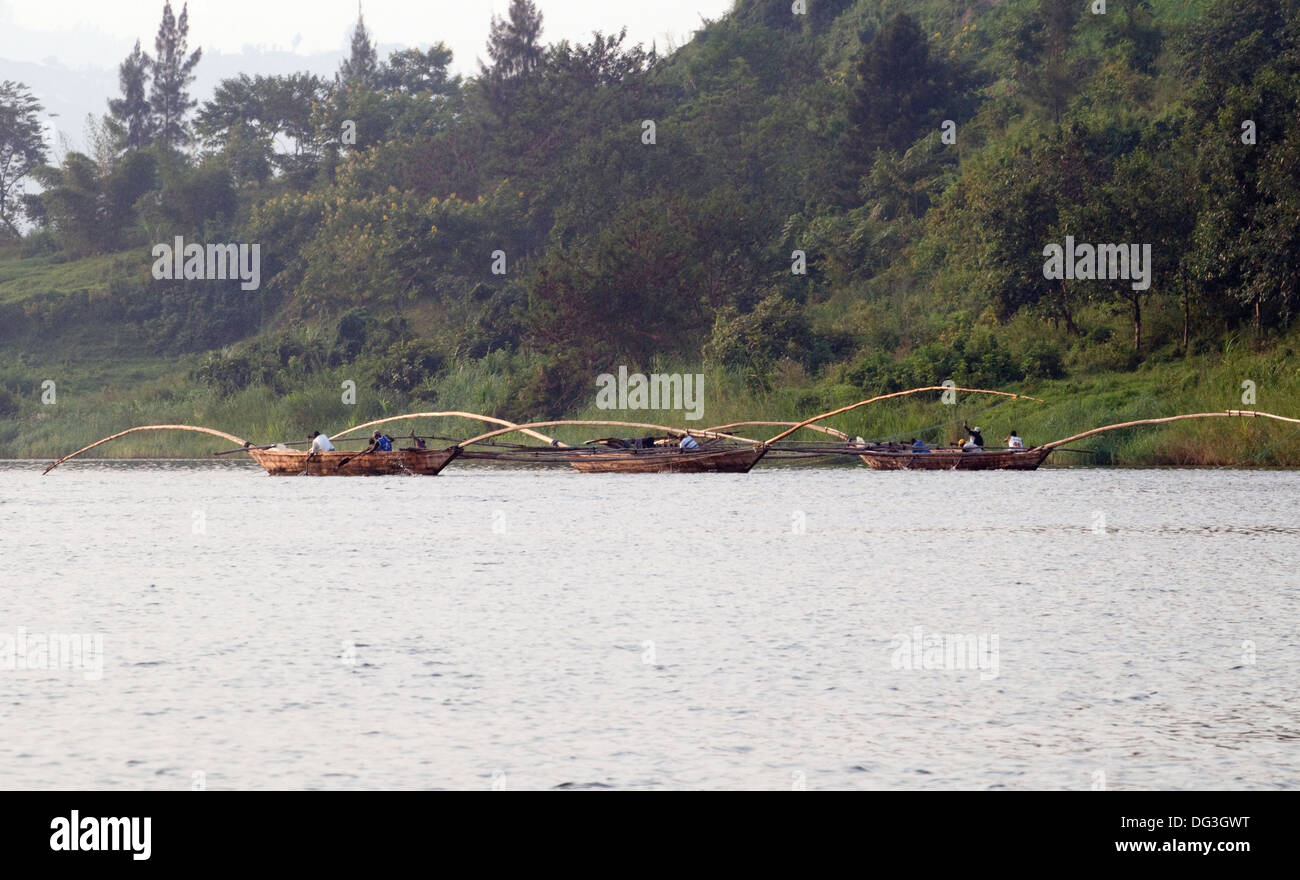Flotilla of fishing boats working together with extended poles trawling ...