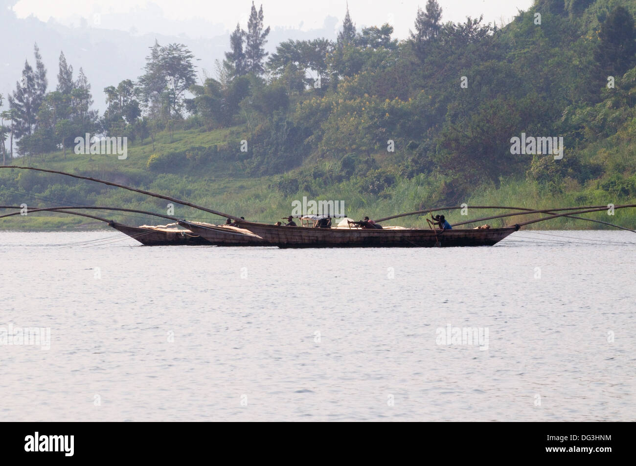 Flotilla of fishing boats working together with extended poles trawling ...