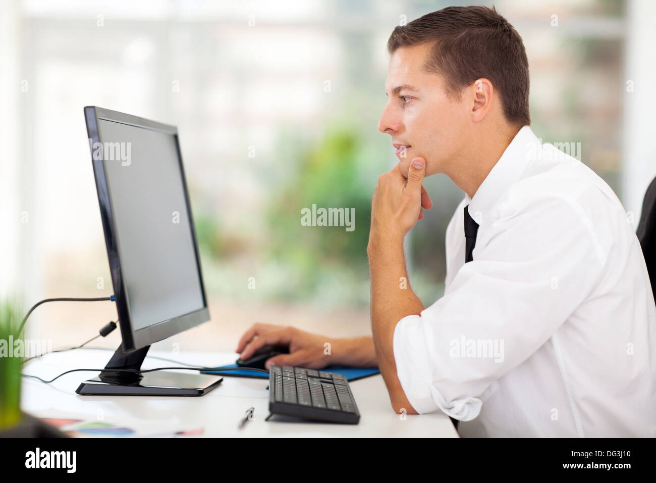 Thoughtful businessman looking computer hi-res stock photography and ...