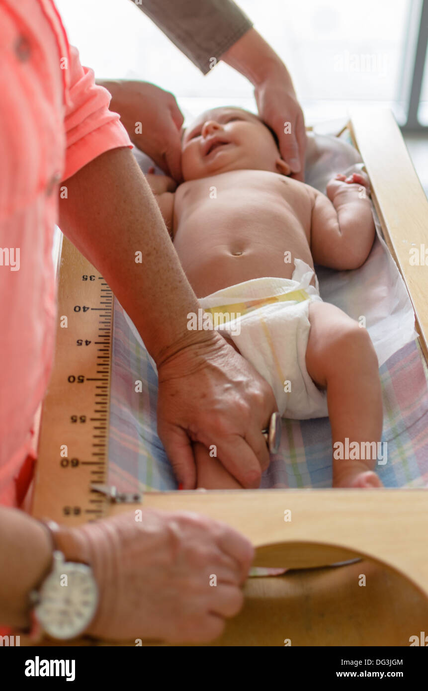 Pediatrician measuring baby's height at a clinic Stock Photo