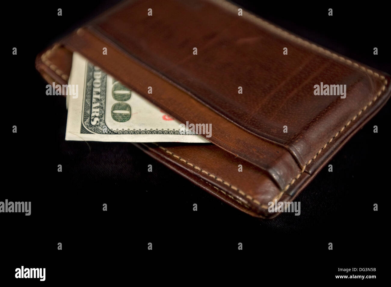 wallet with hundred dollars bill on black background Stock Photo