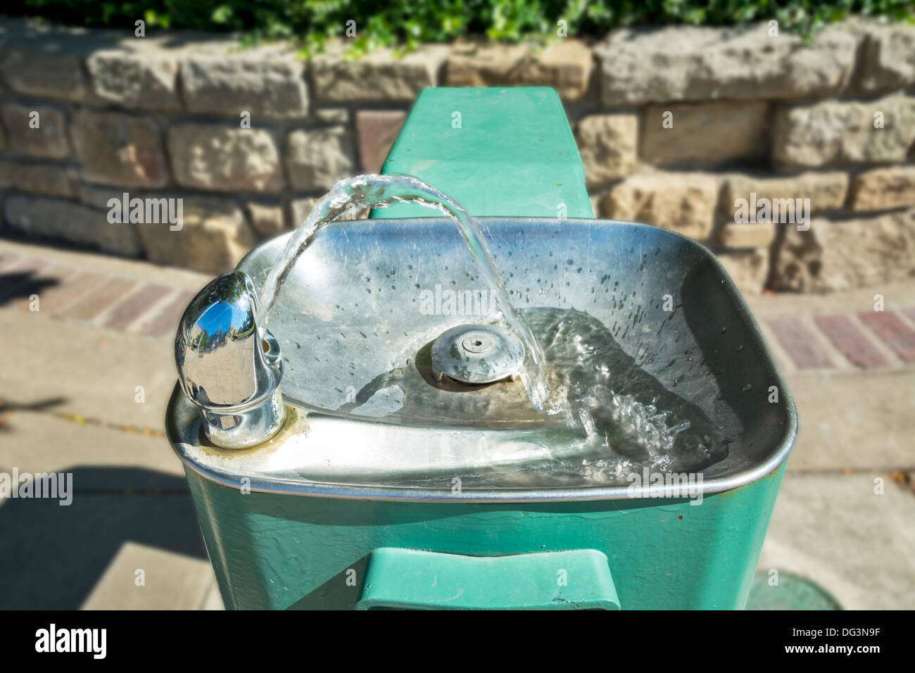 Green sity park water fountain on a sunny day Stock Photo